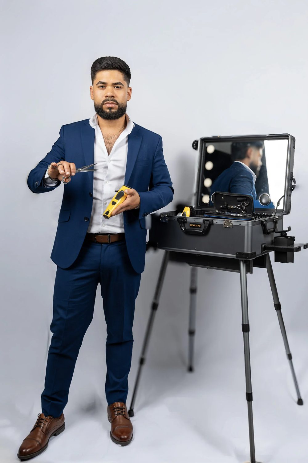 David Caridad at work beside his lit station mirror