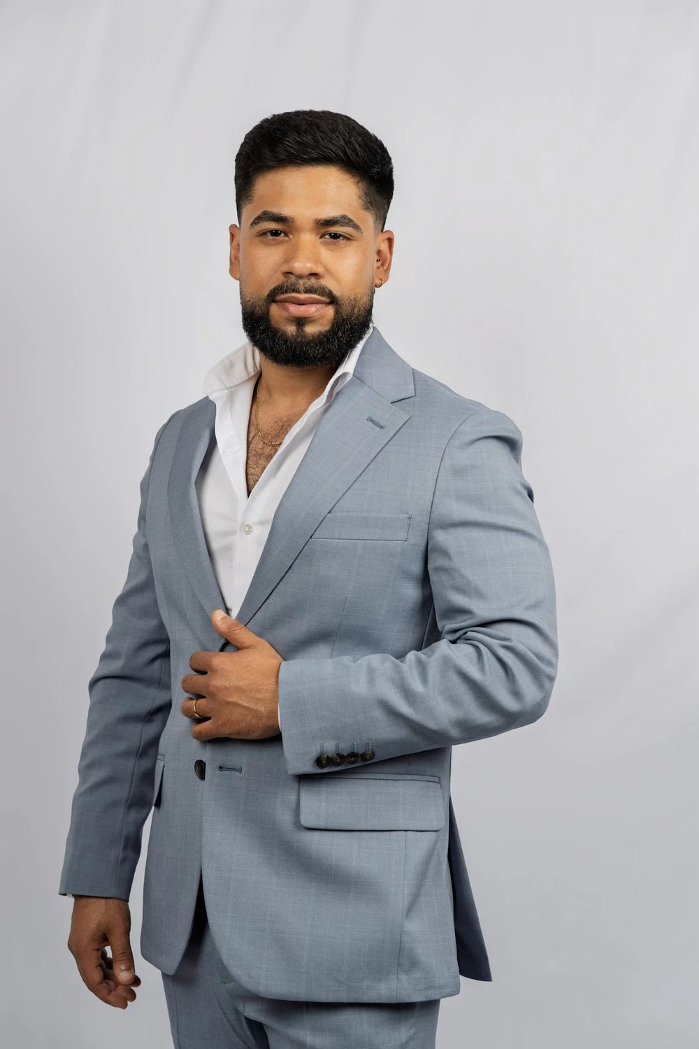 Portrait of David Caridad in a navy suit