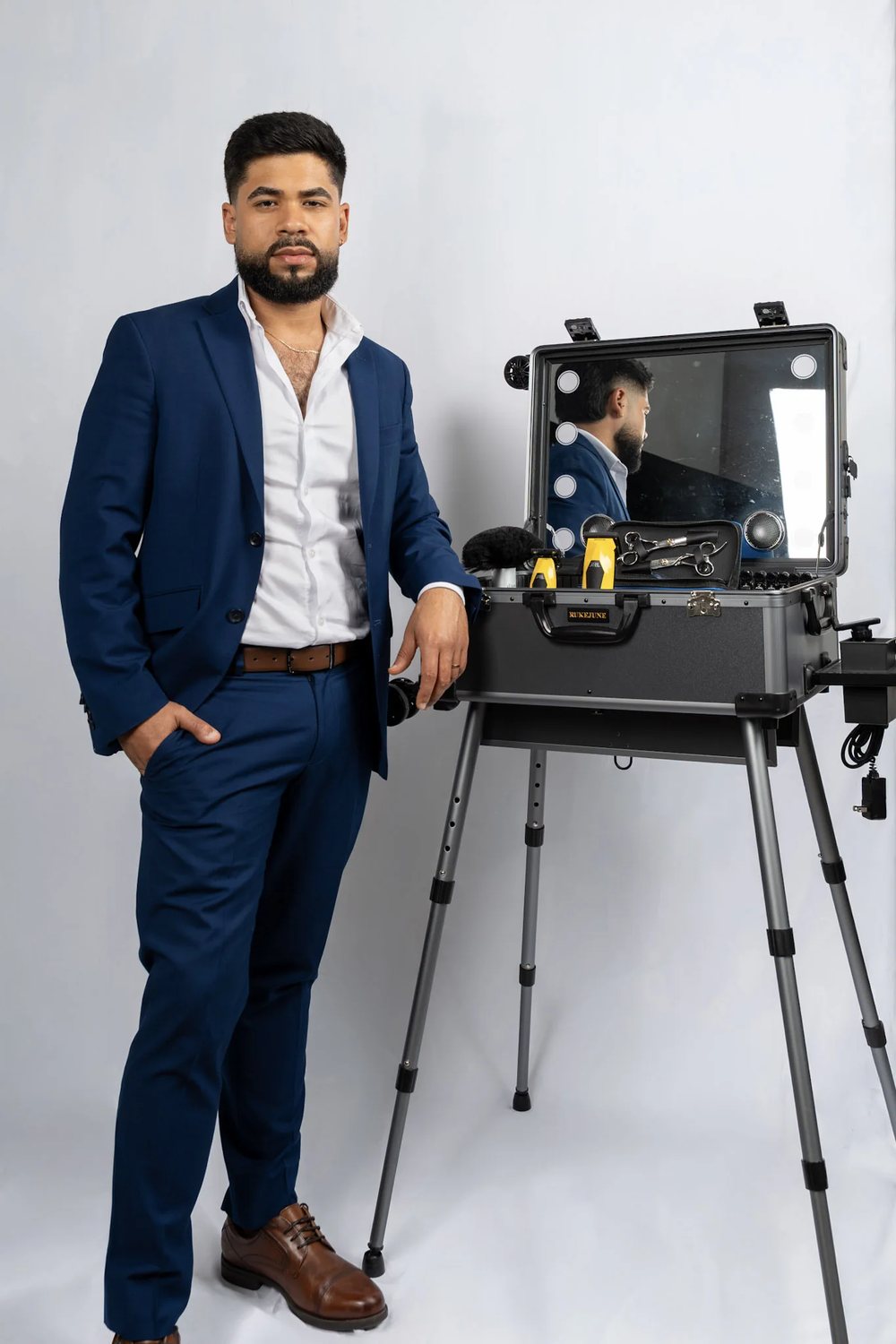David Caridad beside his fully equipped mobile barber station