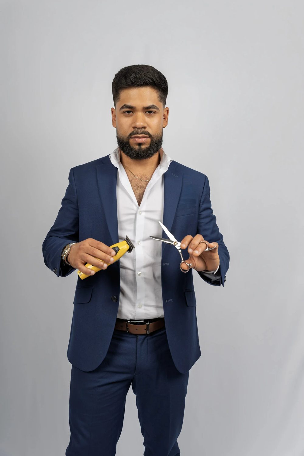 David Caridad holding his clippers and shears
